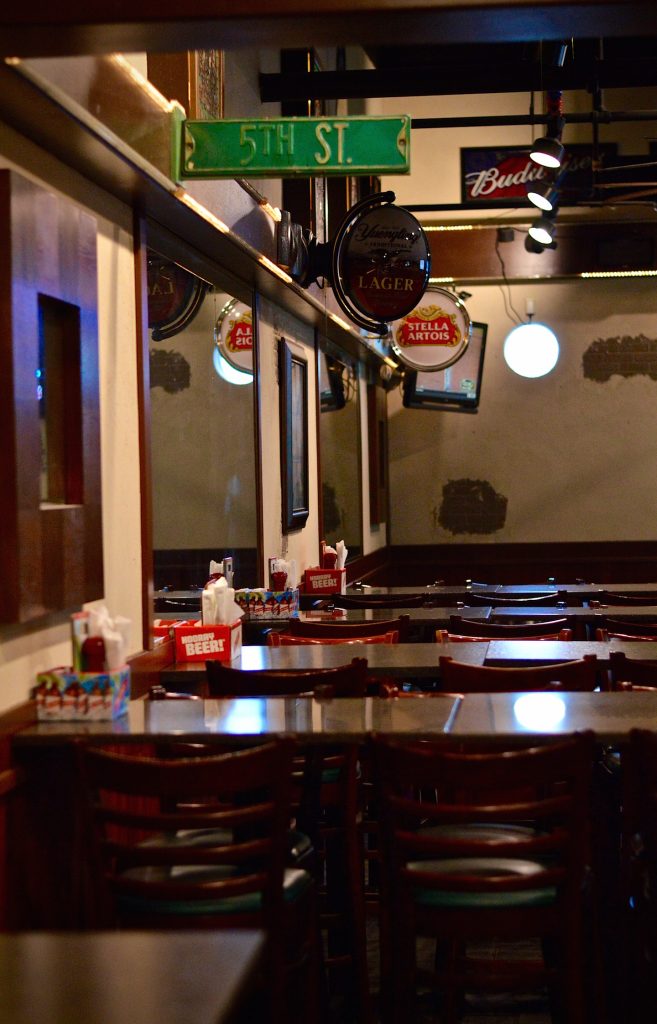 Bar Stools and Tables with lighting and signs above