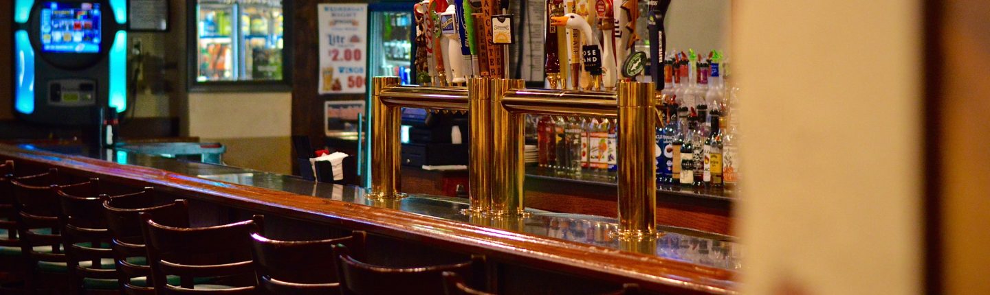 Bar Stools and Bar with Different Beers on Tap