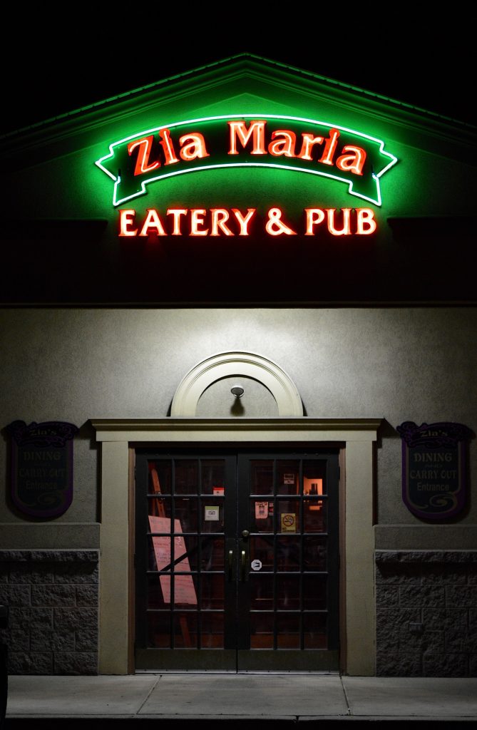 Front of Zia Maira Restaurant and Pub with Glowing Neon Sign