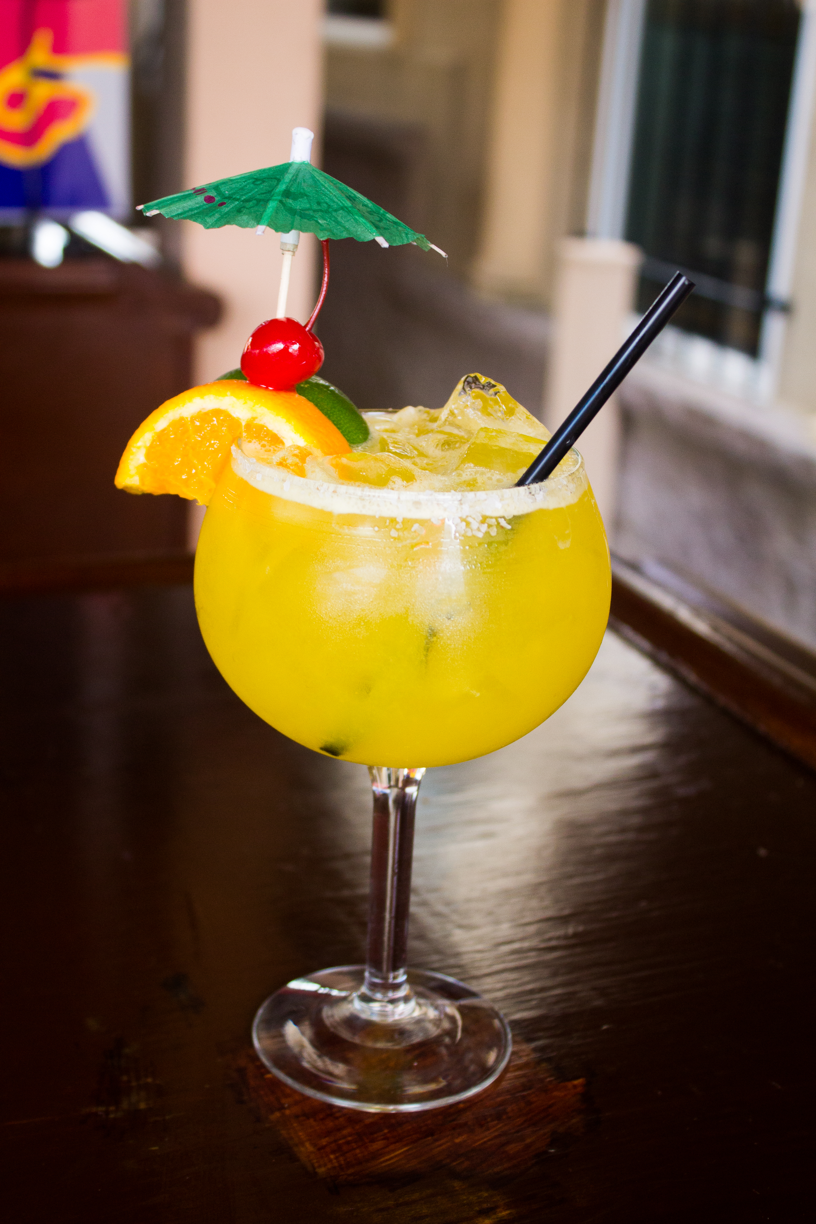 Summer Cocktail w/ orange and lime slice and cherry