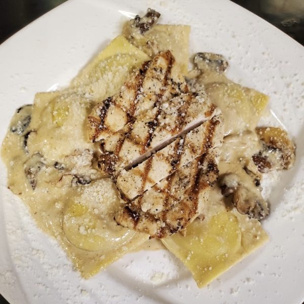 stuffed ravioli portabella tossed with creamy alfredo and wild mushrooms and topped with grilled chicken