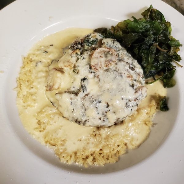 portabella mushroom with spinach and shrimp stuffing, pan sautéed with a creamy lemon sauce, served on a bed of rice
