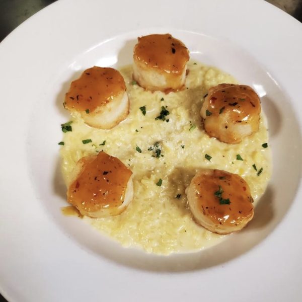 pan seared scallops glazed with a citrus herb sauce, served with risotto